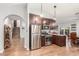Cozy kitchen featuring stainless steel appliances and dark cabinets, along with staircase and hardwood flooring at 2321 N Glenview --, Mesa, AZ 85213