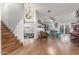 Bright living area showcasing hardwood floors, staircase, and comfortable seating arrangement with open concept at 2321 N Glenview --, Mesa, AZ 85213