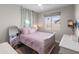 Soft pink bedroom features a full-size bed with ivy décor and a vanity at 24626 N 143Rd Dr, Surprise, AZ 85387