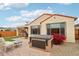 Relaxing backyard with a hot tub, patio furniture, and low-maintenance landscaping, perfect for outdoor gatherings at 27467 W Osprey Dr, Buckeye, AZ 85396