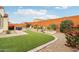 Spacious backyard featuring artificial turf, landscaping, a hot tub, and ample space for outdoor enjoyment at 27467 W Osprey Dr, Buckeye, AZ 85396