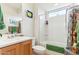 Well-lit bathroom featuring a single vanity, toilet, shower/tub combination, and colorful decor at 27467 W Osprey Dr, Buckeye, AZ 85396