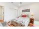 Cozy bedroom with wood floors, a colorful quilt, and ample closet space at 27467 W Osprey Dr, Buckeye, AZ 85396