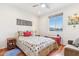 Bright bedroom with wood floors, a cozy quilt, natural light, and decorative art at 27467 W Osprey Dr, Buckeye, AZ 85396