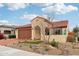 Charming single-story home featuring a desert landscape, red tile roof, and a welcoming arched entrance at 27467 W Osprey Dr, Buckeye, AZ 85396