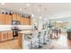 Open kitchen with an island and bar seating, adjacent to the dining area and stainless appliances at 27467 W Osprey Dr, Buckeye, AZ 85396