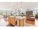 Open concept kitchen with granite counters, stainless appliances, and views to living room and dining room at 27467 W Osprey Dr, Buckeye, AZ 85396