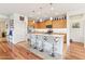 Open kitchen with granite counters, bar seating, stainless appliances, and light wood cabinetry at 27467 W Osprey Dr, Buckeye, AZ 85396