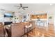 Open-concept space featuring a stone fireplace, hardwood flooring, and a modern kitchen in the background at 27467 W Osprey Dr, Buckeye, AZ 85396