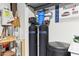 Utility closet featuring SpringWell water filtration systems, shelving, and other equipment at 27467 W Osprey Dr, Buckeye, AZ 85396