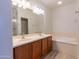 Bathroom showcasing a double vanity, a soaking tub, and modern finishes for a spa-like retreat at 29120 N 22Nd Ave # 205, Phoenix, AZ 85085