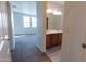 Bright bathroom featuring a double sink vanity with a wood finish and modern lighting at 29120 N 22Nd Ave # 205, Phoenix, AZ 85085