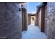 Close-up of exterior walkway with private entrance and stone facade detailing at 29120 N 22Nd Ave # 205, Phoenix, AZ 85085