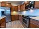 Close up of the kitchen showing the stainless steel appliances and wood cabinetry at 29120 N 22Nd Ave # 205, Phoenix, AZ 85085
