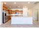 Spacious kitchen featuring a large island, stainless steel appliances, and light wood cabinets at 29120 N 22Nd Ave # 205, Phoenix, AZ 85085
