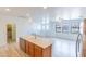 Bright, open kitchen features a large island with sink, stainless steel appliances, and lots of natural light at 29120 N 22Nd Ave # 205, Phoenix, AZ 85085