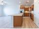 Open-concept kitchen featuring a large island with sink and stainless-steel appliances at 29120 N 22Nd Ave # 205, Phoenix, AZ 85085