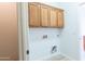 Convenient laundry area with overhead cabinets and utility connections at 29120 N 22Nd Ave # 205, Phoenix, AZ 85085