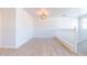 Neutral loft space featuring modern lighting, wood-style floors and an open layout at 29120 N 22Nd Ave # 205, Phoenix, AZ 85085