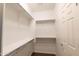 Walk-in closet with built-in shelving for organized storage at 29120 N 22Nd Ave # 205, Phoenix, AZ 85085