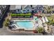 Bird's-eye view of community pool, hot tub, lounge chairs, green foliage and townhomes at 3200 N 39Th St # 4, Phoenix, AZ 85018