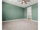 Expansive green bedroom with a ceiling fan opens to the ensuite bathroom at 3200 N 39Th St # 4, Phoenix, AZ 85018