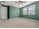 Green bedroom with large window and closet boasts a ceiling fan and plenty of natural light at 3200 N 39Th St # 4, Phoenix, AZ 85018