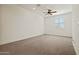Bright, carpeted bedroom with ceiling fan features natural light from the window at 3200 N 39Th St # 4, Phoenix, AZ 85018
