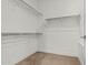 Walk-in closet with ample shelving and storage space, featuring neutral carpet at 3200 N 39Th St # 4, Phoenix, AZ 85018