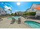 Community pool area with lounge chairs, umbrellas, and a jacuzzi at 3200 N 39Th St # 4, Phoenix, AZ 85018