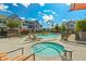 Community pool area with lounge chairs, umbrellas, and a jacuzzi at 3200 N 39Th St # 4, Phoenix, AZ 85018