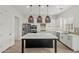 Bright kitchen features a large island with quartz countertop, stainless appliances, and tile backsplash at 3200 N 39Th St # 4, Phoenix, AZ 85018