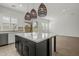 Kitchen featuring a large island with quartz countertop, stainless appliances, and access to the patio at 3200 N 39Th St # 4, Phoenix, AZ 85018