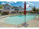 Community pool featuring lounge chairs, umbrellas, and stylish townhomes in the background, perfect for relaxing and enjoying sunny days at 3200 N 39Th St # 4, Phoenix, AZ 85018