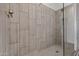 Close up of a modern shower with glass partition and decorative neutral colored tiling at 3200 N 39Th St # 4, Phoenix, AZ 85018