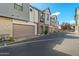 Modern townhomes with gray siding and private garages lining a quiet street with manicured landscaping at 3200 N 39Th St # 4, Phoenix, AZ 85018