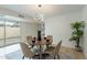 Chic dining area with decorative lighting, seating for four, and sliding glass doors to backyard patio at 3207 W Royal Palm Rd, Phoenix, AZ 85051