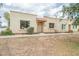 Tan stucco exterior with a red tiled entry and small landscaped features at 3207 W Royal Palm Rd, Phoenix, AZ 85051