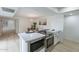 Well-lit kitchen showcasing stainless steel appliances, quartz countertops, and an adjacent dining area at 3207 W Royal Palm Rd, Phoenix, AZ 85051