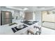 Modern kitchen with breakfast bar seating and an adjacent dining area with access to backyard patio at 3207 W Royal Palm Rd, Phoenix, AZ 85051