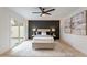 Well-appointed bedroom with a private patio, dark accent wall, plush bedding, and modern furnishings at 3207 W Royal Palm Rd, Phoenix, AZ 85051
