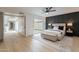 Beautiful bedroom offering dark accent wall, bench, and ensuite bathroom providing comfort and privacy at 3207 W Royal Palm Rd, Phoenix, AZ 85051