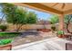 Inviting backyard featuring a built-in fire pit, lush landscaping, and a covered patio for outdoor entertaining at 3285 E Phelps St, Gilbert, AZ 85295