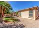 Spacious backyard with well-maintained lawn, stone accents, desert landscaping, and a covered patio for outdoor enjoyment at 3285 E Phelps St, Gilbert, AZ 85295