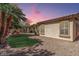 An inviting backyard with manicured lawn, mature trees, and a cozy fire pit at 3285 E Phelps St, Gilbert, AZ 85295
