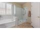 Modern bathroom featuring a glass-enclosed shower and soaking tub combo, offering a luxurious and relaxing experience at 3285 E Phelps St, Gilbert, AZ 85295