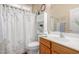 Well-maintained bathroom featuring a vanity, built-in shelves, and shower-tub combo at 3285 E Phelps St, Gilbert, AZ 85295