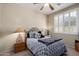 Cozy bedroom with a ceiling fan, neutral walls and window shutter at 3285 E Phelps St, Gilbert, AZ 85295