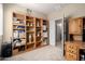 Bright bedroom featuring built-in bookshelves and access to an adjacent room, offering ample storage and space at 3285 E Phelps St, Gilbert, AZ 85295