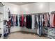 Organized walk-in closet filled with a variety of clothing, maximizing storage and accessibility at 3285 E Phelps St, Gilbert, AZ 85295